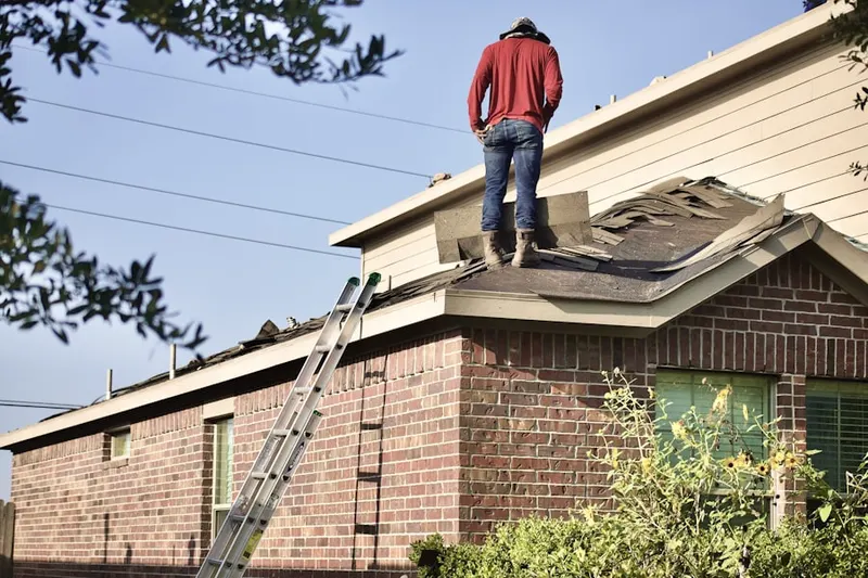 Professional roofer working on a residential roof in Regal